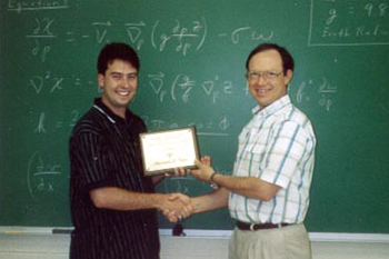 Chris Davis receives the 1998 Synoptic Meteorology: Top Forecaster Award from Dr. Keith Blackwell.