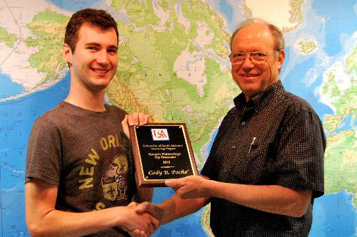 Cody Poche receives the 2015 Top Forecaster Award from Dr. Keith Blackwell.