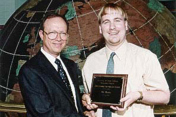Jason Beaman receives the 2003 Synoptic Meteorology Top Forecaster Award from Dr. Keith Blackwell.