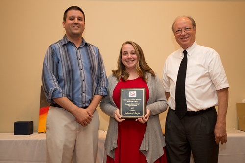 Juliana Bayhi receives the 2017 Top Forecaster Award from Dr. Keith Blackwell and Andrew Murray.