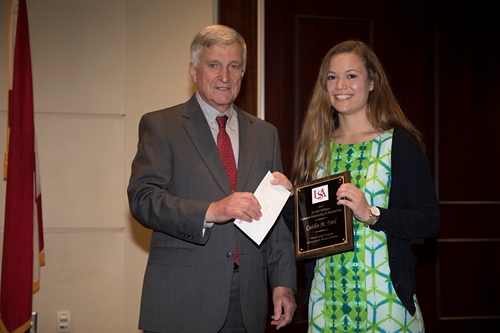 Dr. Bill Williams presents an Endowment Scholarship to Caitlin Ford.