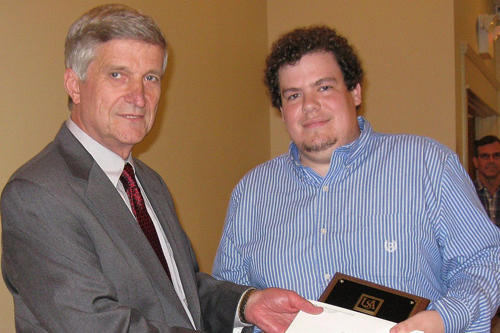 Carter Hulsey receives award from Dr. Bill Williams
