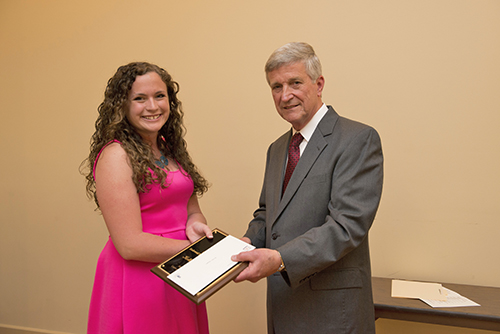 Kelly Neugent is congratulated by Dr. Bill Williams.