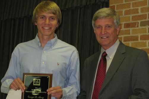 Trey Alvey receives award from Dr. Bill Williams