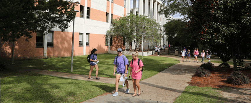 Students walking outside the Humanities building where the English department is located.
