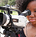 Female student looking through camera