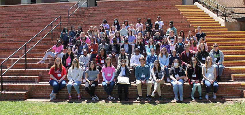 Group at Girls in Math Day sitting on steps outside of the Student Center. data-lightbox='featured'