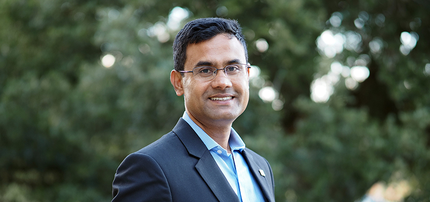 Dr. Mohammad Delwar Hossain standing outside on campus.