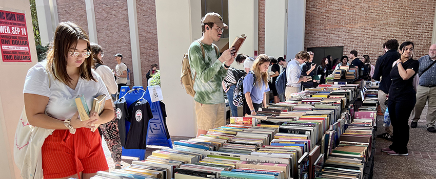 Students looking through records outside on campus.