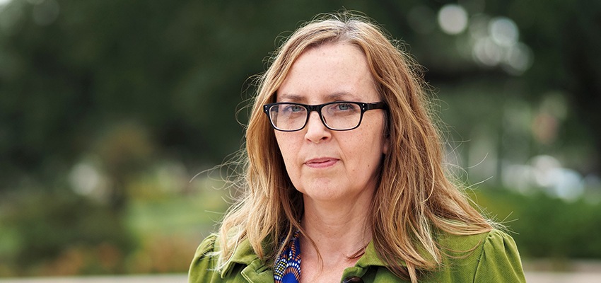 Dr. Marie Léonard standing outside on campus.