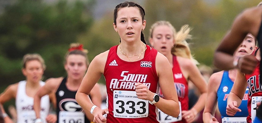 Adele Magaud running a race representing the University of South Alabama.