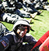 Soldier on field with flag in front of other soldiers