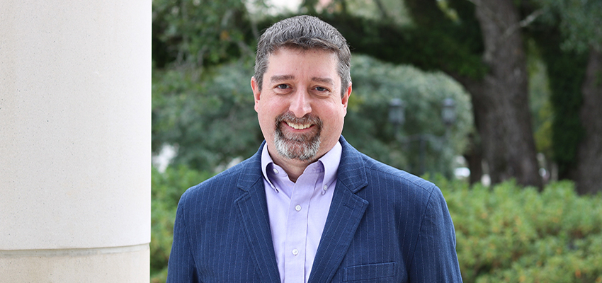 Dr. Matthew Reichert standing  outside on campus.