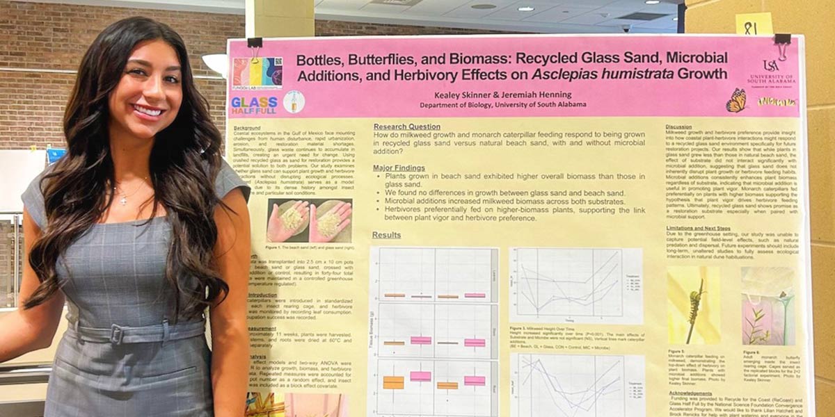 Kealey Skinner standing in front of winning Biology poster.