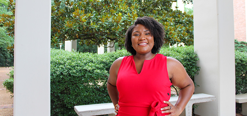 Taylor Davis standing outside of Humanities building.