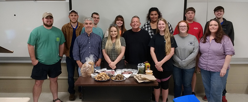Jewish and Holocaust Studies students in front of class with food prepared
