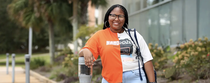 Female student standing outside of the library.