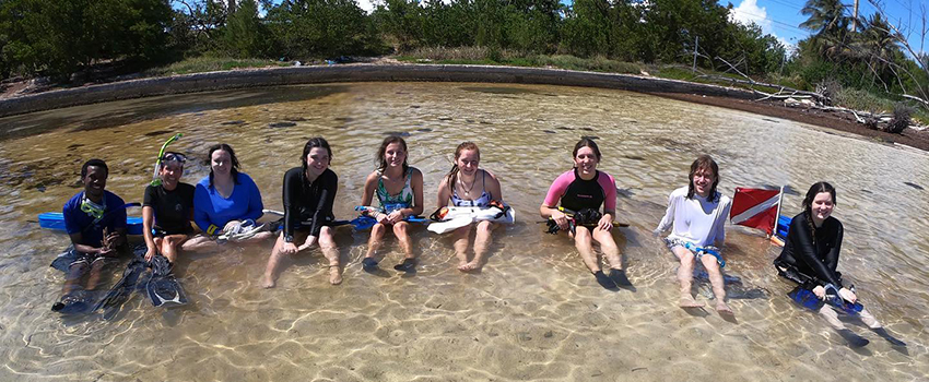 marine science students sitting in water