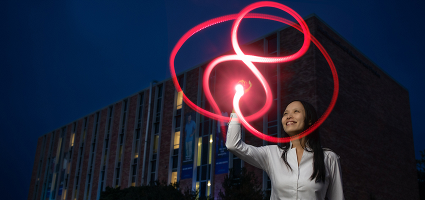 Dr. Christine Ruey Shan Lee traces a figure-eight knot with light outside the Mathematical Sciences and Physics Building at the University of South Alabama. Her research in quantum topology earned a grant from the National Science Foundation.