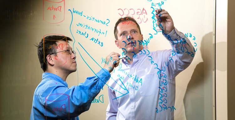 Dr. Jingshan Huang, left, professor of computer sciences, and Dr. Glen Borchert, an assistant professor of pharmacology and biology, are two USA researchers working in the field of informatics. The two have collaborated on projects.