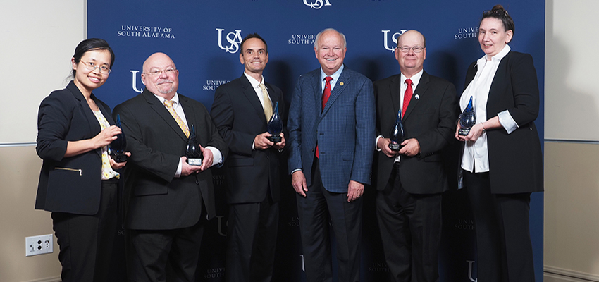 Showcase honorees holding their awards with President Jo Bonner.