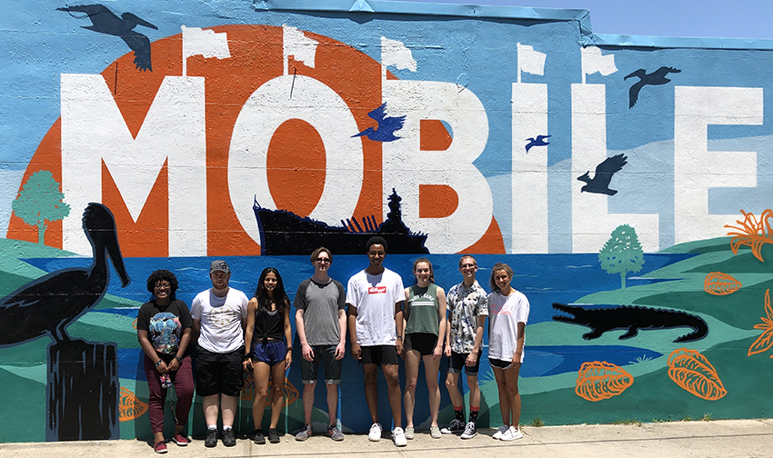 REU Students in front of wall with Mobile painted on it