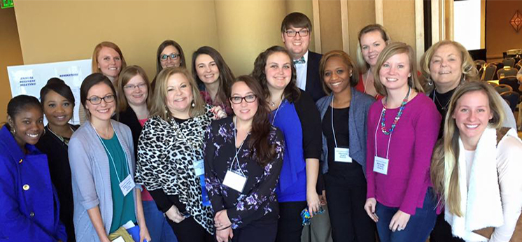 Laurie Haas, Field Instruction Coordinator and Melanie Bankhead, Instructor of Social Work, with current students and alumni from the BSW program at USA