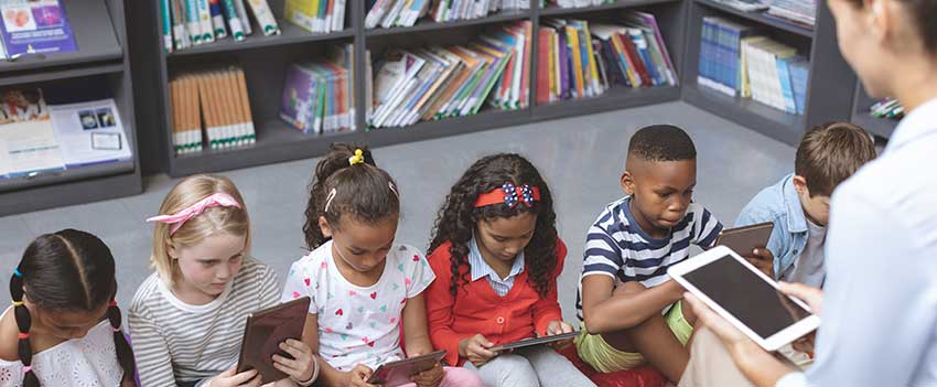 Children reading books in class.