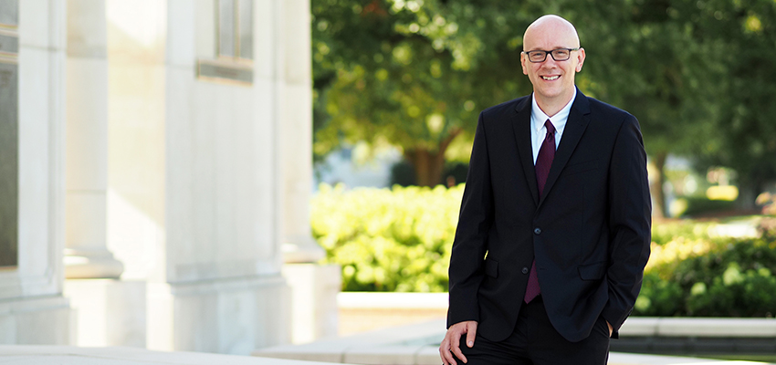 Dr. Allday standing outside on campus.