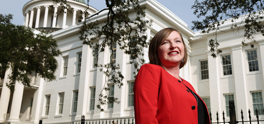 Amanda Jones standing in front of Barton academy.