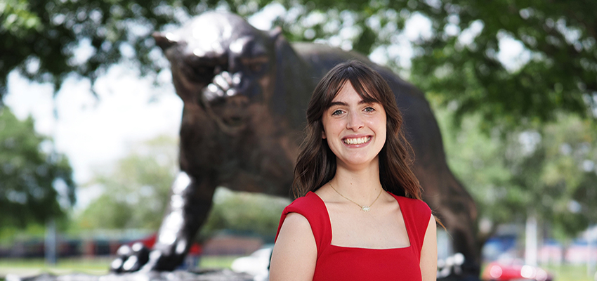 Annie Mascia in front of Jaguar statue.