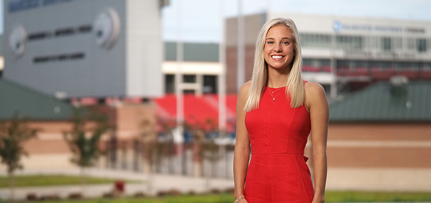 Camille Bonura standing in front of Hancock Whitney Stadium.