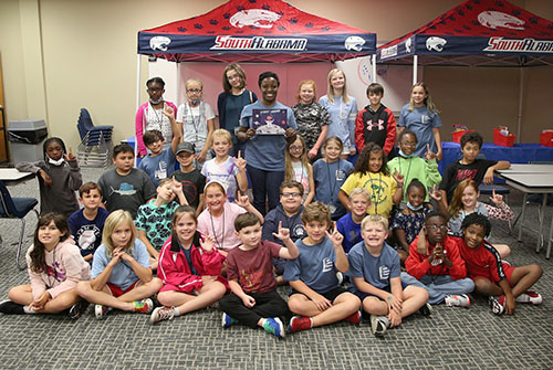 Summer campers in front of Jags background.