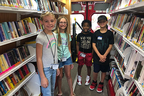 Four campers in the library.