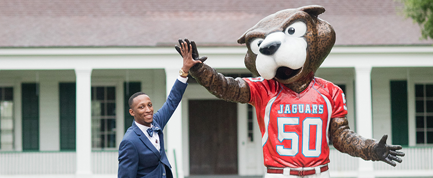 Male giving Southpaw statue high five.