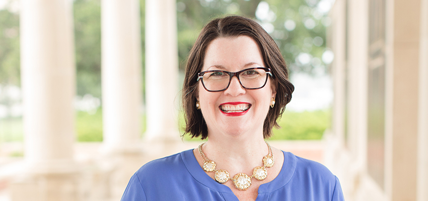 Dr. Peggy Delmas standing outside on campus.