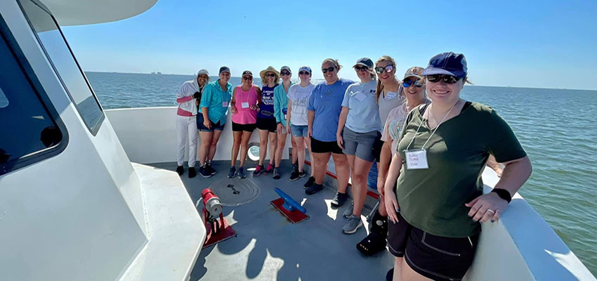 Students on boat in the ocean.