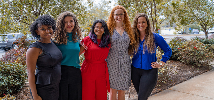 Clinical and Counseling Psychology Doctoral Students standing outside of the CEPS building on campus. data-lightbox='featured'