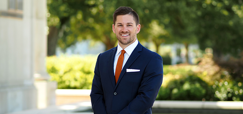 Dr. Joshua Keller standing outside on campus.