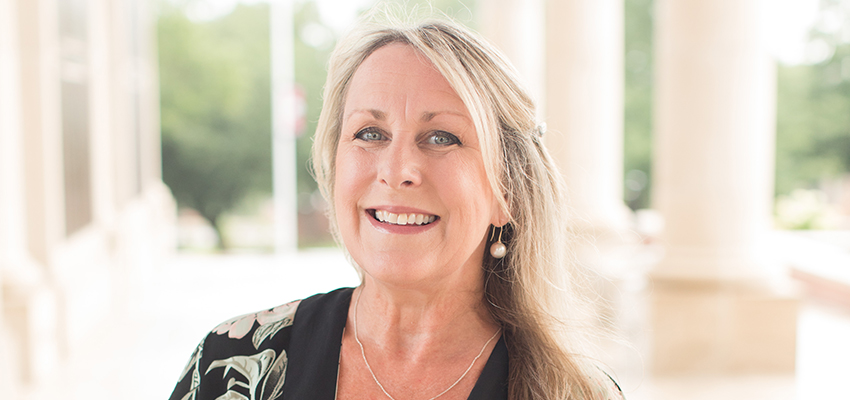 Dr. Kelly Byrd standing outside on campus.