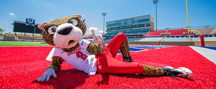 Southpaw holding up the J sign for Jaguars on the football field.