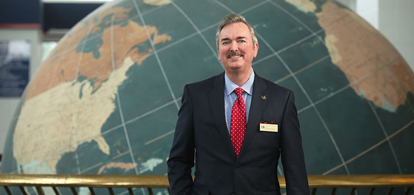 Robert Thompson standing in front of Waterman Globe. data-lightbox='featured'