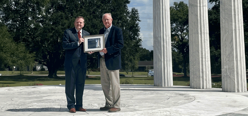 Dr. Damon Andrew and Dr. John E Kovaleski holding a plaque representing undergraduate scholarship to honor Dr. John E Kovaleski.