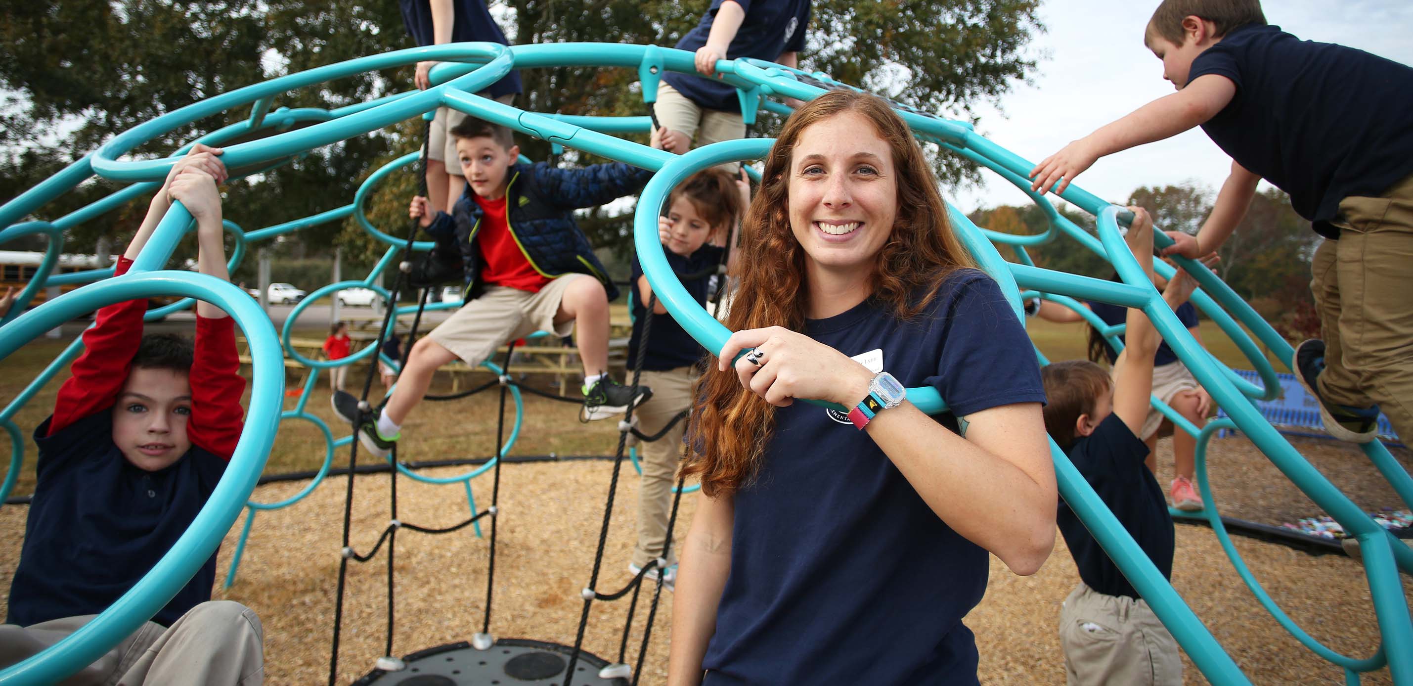 Shelby Lynn pictured with kids on playground aparatus