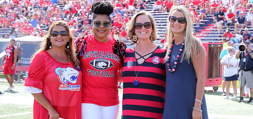 Teachers on field with dr. Kent