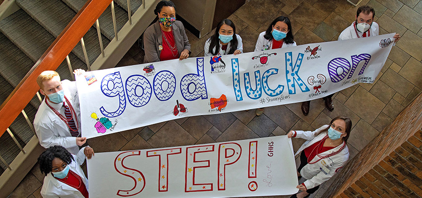 GHHS members hold banners encouraging the next group of students taking the United States Medical Licensing Examination Step 1.