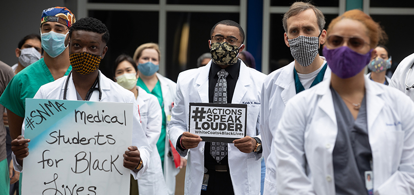 Medical students, residents and faculty gather for a WhiteCoats4BlackLives event at USA Health.