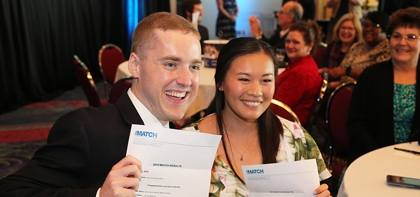 Medical students at the USA College of Medicine display their match letters at 2019's Match Day Ceremony.