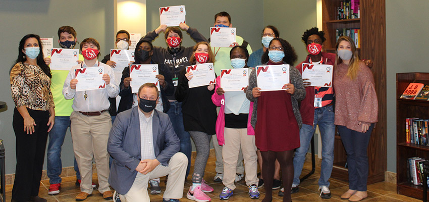 PASSAGE USA students display certificates earned at the end of the program.  data-lightbox='featured'
