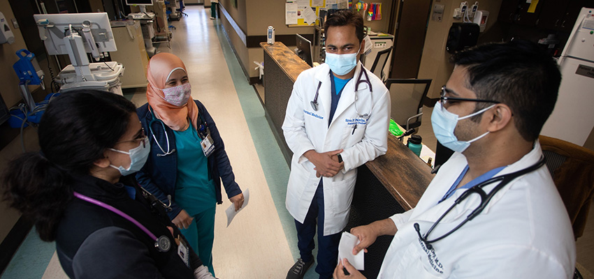 Siva Parcha, M.D., second from right, assistant professor of internal medicine, rounds at University Hospital with a team of internal medicine residents, from left, Seema Mir, M.D., Samar Abohamad, M.D., and Andrew Dep, M.D.